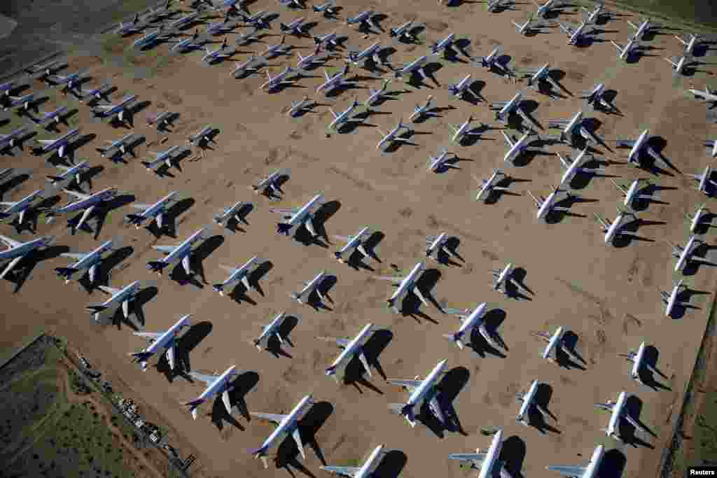 Old airplanes, including Boeing 747-400s, are stored in the desert in Victorville, California.