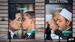 A Benetton clothing store window in Paris is covered by posters showing Pope Benedict XVI kissing Egypt's Ahmed el Tayyeb and US president Barack Obama kissing his China's Hu Jintao, November 17, 2011.