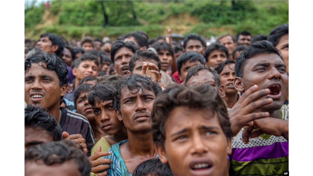 Rohingya Muslims, who crossed over from Myanmar into Bangladesh, wait their turn to collect aid near Balukhali refugee camp, Bangladesh, Sept. 20, 2017.