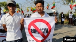 People protest while Malaysian NGO's aid ship carrying food and emergency supplies for Rohingya Muslims arrives at the port in Yangon, Myanmar, Feb. 9, 2017.