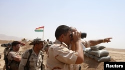 ក្រុម​សកម្មប្រយុទ្ធ​ Peshmerga របស់​ក្រុម​យោធា​ Kurde យាមត្បាត​នៅ​ជាយ​ក្រុង​ Gwer Town កាលពី​ថ្ងៃទី១៨ ខែសីហា ឆ្នាំ២០១៤។