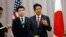 Japanese Prime Minister Shinzo Abe, right, answers questions from the media after meeting with then U.S. President-elect Donald Trump during his stopover in New York, Nov. 17, 2016. Abe was en route to an APEC meeting in Lima, Peru.