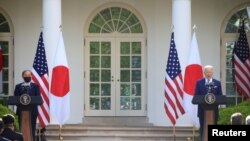 Japan's Prime Minister Yoshihide Suga and U.S. President Joe Biden hold a joint news conference in the Rose Garden at the White House in Washington, U.S., April 16, 2021. 