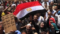 Egyptians shout during a protest in Tahrir Square, the focal point of uprising, June 3, 2011