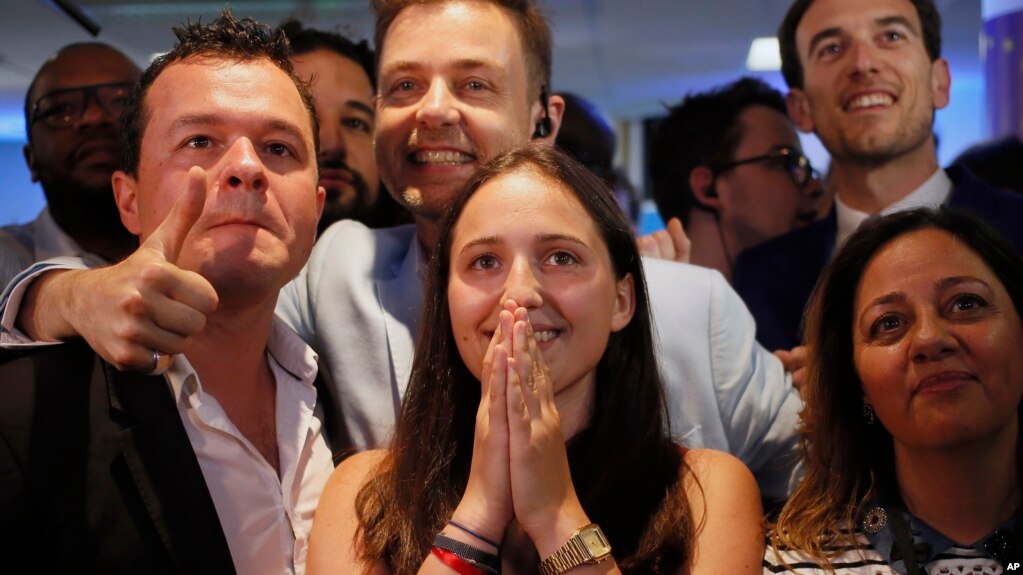 La Republique en Marche party members react after the announcement of the partial official results and polling agencies projections in the final round of parliamentary elections are announced at the party's headquarters, in Paris, France, June 18, 2017.