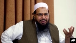 FILE - In this April 3, 2012, Hafiz Mohammed Saeed, chief of Jamaat-ud-Dawwa and founder of Lashkar-e-Taiba, talks with the Associated Press in Islamabad, Pakistan.