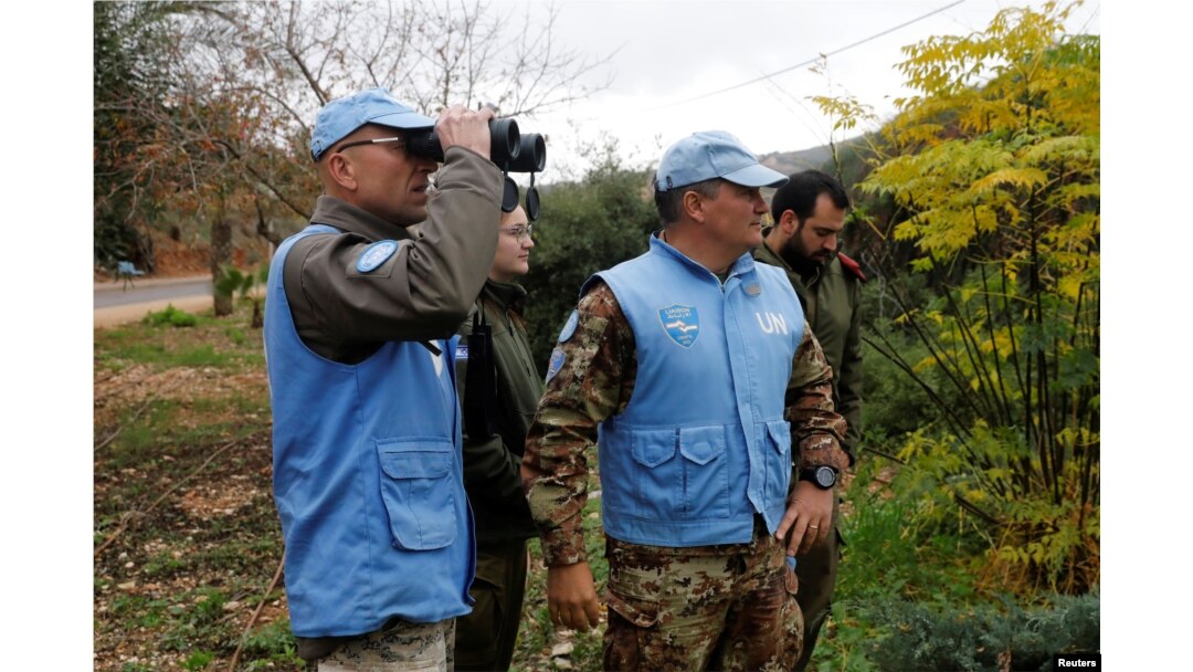 U.N. peacekeepers and Israeli soldiers look towards the border with Lebanon the morning after the Israeli military said it had launched an operation to "expose and thwart" cross-border attack tunnels from Lebanon, in Israel's northernmost town Metula, Dec. 5, 2018.