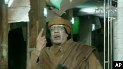This image broadcast on Libyan state television, February 22, 2011, shows country's leader Moammar Gadhafi reportedly addressing the nation from Tripoli