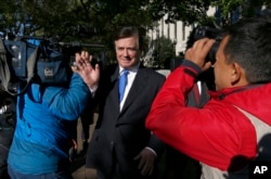 FILE - Paul Manafort makes his way through television cameras as he walks from U.S. District Court in Washington, Oct. 30, 2017.