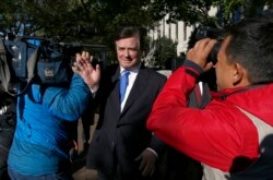 FILE - Paul Manafort makes his way through television cameras as he walks from Federal District Court in Washington, Oct. 30, 2017.