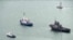 This video grab provided by the Krym 24 tv station via AP Television shows a seized Ukrainian ship, right, is towed by a Russian coast guard boat out of the port in Kerch, Crimea, Nov. 17, 2019. 