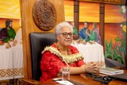 FILE - This picture released by the Samoa Observer on July 27, 2021, shows Samoa's new Prime Minister Fiame Naomi Mata'afa holding her cabinet's first meeting at the Government Building in Apia.