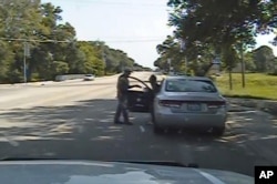 FILE - Frame from a dashcam video provided by the Texas Department of Public Safety shows a heated confrontation between trooper Brian Encinia with Sandra Bland after a minor traffic infraction, July 10, 2015.