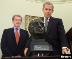 FILE - U.S. President George W. Bush inspects a bust of Winston Churchill presented by British Ambassador Christopher Meyer in the Oval Office of the White House in Washington, July 16, 2001. The bust was on loan from Tony Blair, then the prime minister of Britain.