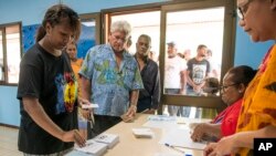 People line up at a polling station in Noumea, New Caledonia, as they prepare to cast their votes as part of an independence referendum, Nov. 4, 2018.