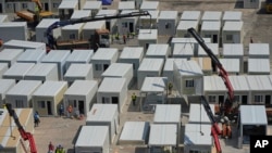 FILE - An aerial view shows a construction site of a new makeshift COVID-19 hospital and isolation facilities in Tsing Yi of Hong Kong, on Feb. 26, 2022. 