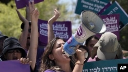 FILE - An Israeli activist leads chants during a protest against plans to overhaul the judicial system, in the West Bank settlement of Kdumim on July 28, 2023. Israel’s Supreme Court said on Sept. 5, 2023, it would delay one of three hearings on the legality of the overhaul.