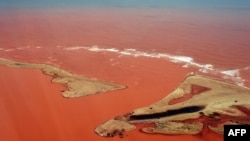 Handout picture released by the Espirito Santo State Press Office showing an aerial view of the Doce River - which was flooded with toxic lama after a dam owned by Brazilian Vale SA and Australian BHP Billiton Ltd. burst early this month - flowing into the Atlantic Ocean in Regencia, Espirito Santo State, Brazil, Nov. 24, 2015.