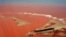 Handout picture released by the Espirito Santo State Press Office showing an aerial view of the Doce River - which was flooded with toxic lama after a dam owned by Brazilian Vale SA and Australian BHP Billiton Ltd. burst early this month - flowing into the Atlantic Ocean in Regencia, Espirito Santo State, Brazil, Nov. 24, 2015.