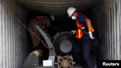 Panama forensic workers work in a container holding a green missile-shaped object seized from the North Korean flagged ship "Chong Chon Gang" at the Manzanillo Container Terminal in Colon City July 17, 2013. U.N. Secretary-General Ban Ki-moon praised Pana