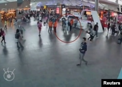 A still image from a CCTV footage appears to show a man purported to be Kim Jong Nam (circled in red) talking to airport staff, after being accosted by a woman in a white shirt, at Kuala Lumpur International Airport in Malaysia, Feb. 13, 2017. Kim later died of poisoning.