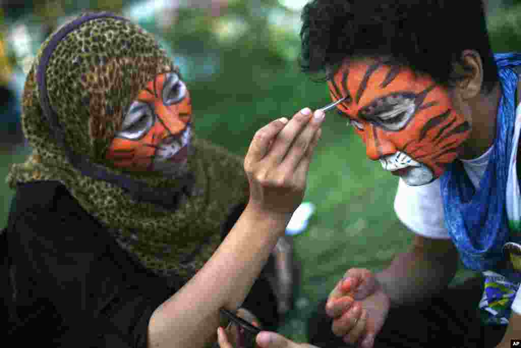 Students paint their faces during a rally calling for Sumatran tiger conservation ahead of the Global Tiger Day in Medan, North Sumatra, Indonesia. The Sumatran tiger is the world&#39;s most critically endangered tiger subspecies with only fewer than 400 remain in the wild and may become extinct in the next decade due to poaching and habitat loss.