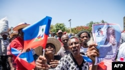 FILE - Haitians demonstrate during a protest to denounce the draft constitutional referendum carried by President Jovenel Moise, on March 28, 2021, in Port-au-Prince. 