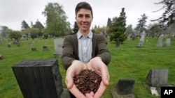 FILE - Katrina Spade, the founder and CEO of Recompose, a company that hopes to use composting as an alternative to burying or cremating human remains, poses for a photo in a cemetery in Seattle.