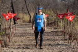 FILE - Britain's Prince Harry walks through a minefield in Dirico, Angola, during a visit to see the work of landmine clearance charity the Halo Trust, on day five of the royal tour of Africa, Sept. 27, 2019.