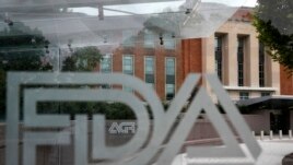 This Aug. 2, 2018, file photo shows the U.S. Food and Drug Administration building behind FDA logos at a bus stop on the agency's campus in Silver Spring, Md. (AP Photo/Jacquelyn Martin, File)
