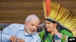 This handout picture from the Brazilian Presidency on Aug. 8, 2023, shows President Luiz Inacio Lula da Silva, left, and Minister of Indigenous Peoples, Sonia Guajajara, chatting during the Amazon Summit IV. 