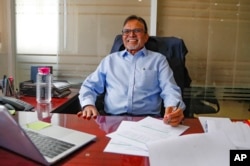 FILE - Rashmi Shah, CP Solar's Managing Director, at his desk in Nairobi, Kenya, Friday, Sept. 1, 2023. Access to electricity remains a challenge for over half a billion people in sub-Saharan Africa. In South Africa and Kenya, solar is being used to power major businesses.