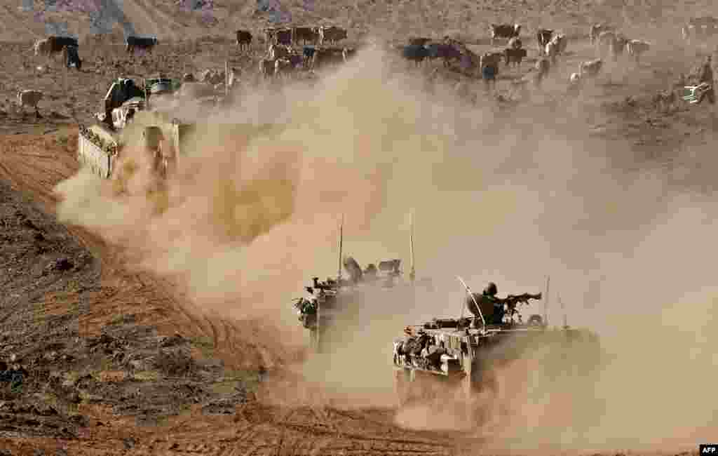 Israeli armored vehicles take part in a drill in the Israeli-annexed Golan Heights, near the border with Syria.