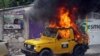 Haiti Protesters Set Fire to Car 