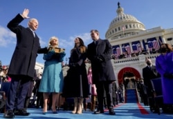 Joe Biden is sworn in as the 46th president of the United States by Chief Justice John Roberts as Jill Biden holds the Bible during the 59th Presidential Inauguration at the U.S. Capitol.