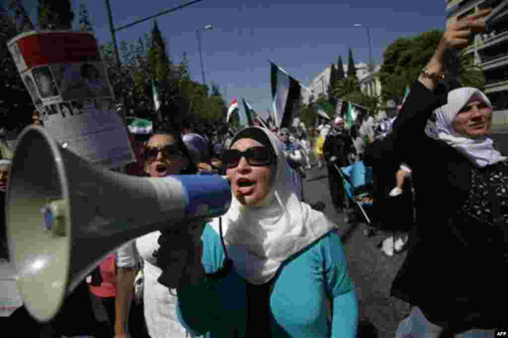 Syrian women living in Greece shout slogans during a protest in Athens following prayers marking the end of the holy month of Ramadan, on Tuesday Aug. 30, 2011. About 300 people marched through the city center to protest against the Syrian regime's violen