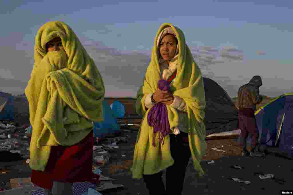 They wrap themselves in blankets to warm up as the sun rises.