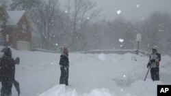 A man shovels snow outside his home in Fairfax, Virginia, 7 Feb. 2010