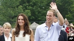 Britain's Prince William waves to spectators while walking with his wife Catherine, Duchess of Cambridge, at Fort Levis in Levis, Quebec July 3, 2011.