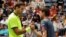 Juan Martin del Potro, of Argentina (L) greets Dominic Thiem, of Austria, after Thiem retired in the second set because of an injury during the fourth round of the U.S. Open tennis tournament, Sept. 5, 2016, in New York. 