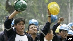 FILE - A group of miners demonstrate against Peru's government at the front of Labor Ministry building in Lima, May 3, 2007. A national strike to back a series of labor-related demands began days later led by Peru's National Federation of Mining, Metallur