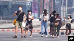 FILE - Tourists wear masks in Chiang Mai province, Thailand, April 2, 2019. The air hanging over Thailand's far north has become so polluted, the prime minister went Tuesday to see in person what's been called a severe health crisis.