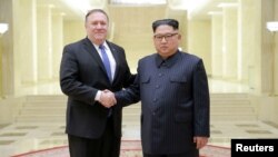 North Korean leader Kim Jong Un shakes hands with U.S. Secretary of State Mike Pompeo in this undated photo released on May 9, 2018 by North Korea's Korean Central News Agency (KCNA) in Pyongyang.