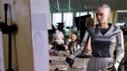 Humanoid robot Sophia, developed by Hanson Robotics, draws on a plastic plate during a demonstration before auctioning her own non-fungible token (NFT) artwork, in Hong Kong, China March 16, 2021. REUTERS/Tyrone Siu