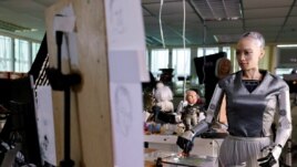 Humanoid robot Sophia, developed by Hanson Robotics, draws on a plastic plate during a demonstration before auctioning her own non-fungible token (NFT) artwork, in Hong Kong, China March 16, 2021. REUTERS/Tyrone Siu