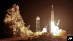 A SpaceX Falcon heavy rocket lifts off from pad 39A at the Kennedy Space Center in Cape Canaveral, Fla., early Tuesday, June 25, 2019. (AP Photo/John Raoux)