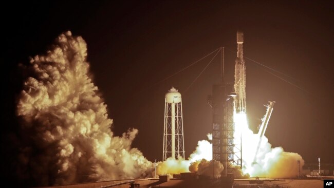 A SpaceX Falcon heavy rocket lifts off from pad 39A at the Kennedy Space Center in Cape Canaveral, Fla., early Tuesday, June 25, 2019. (AP Photo/John Raoux)