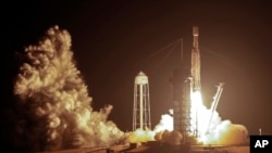 A SpaceX Falcon heavy rocket lifts off from pad 39A at the Kennedy Space Center in Cape Canaveral, Fla., early Tuesday, June 25, 2019. (AP Photo/John Raoux)