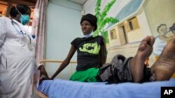 A newly-diagnosed HIV positive woman, who arrived at the hospital with symptoms of tuberculosis (TB), receives treatment at the Mildmay Uganda clinic, which receives funding from the US government through the Centers for Disease Control and Prevention (CD