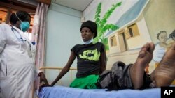 A newly-diagnosed HIV positive woman, who arrived at the hospital with symptoms of tuberculosis (TB), receives treatment at the Mildmay Uganda clinic, which receives funding from the US government through the Centers for Disease Control and Prevention.
